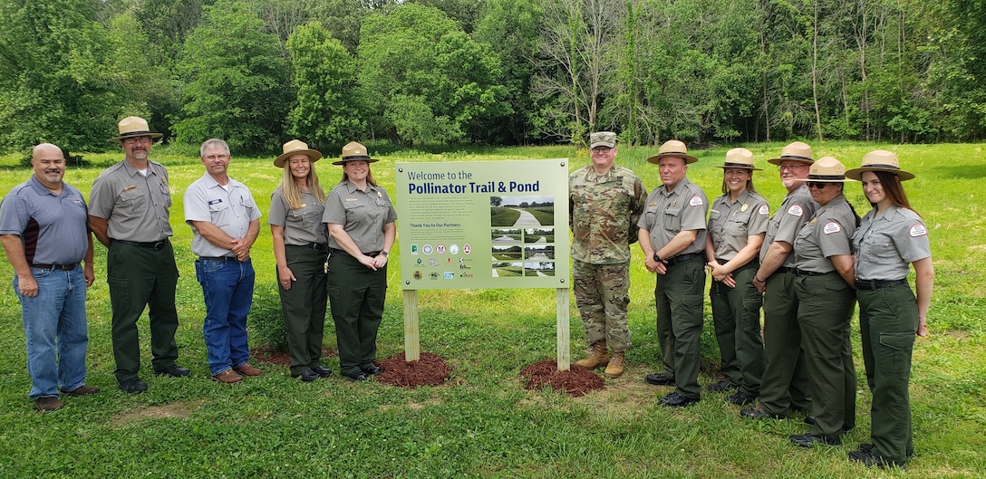 Rend Lake Park Rangers and St. Louis District Leaders celebrate the grand opening of the Catfish Cove Pollinator Area