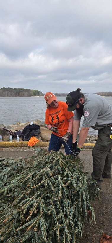 Volunteer and Park Ranger work together to help place fish habitat structures in Rend Lake