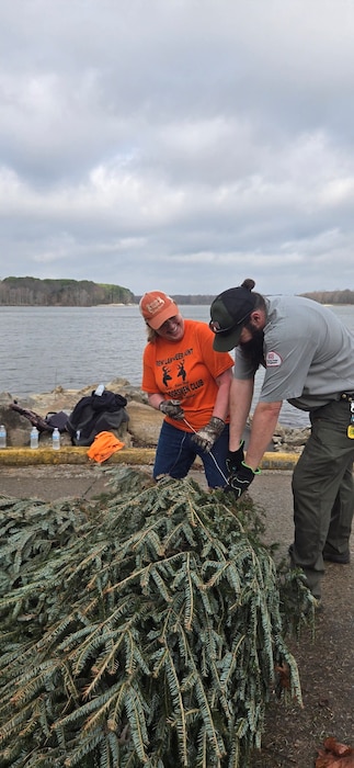 Volunteer and Park Ranger work together to help place fish habitat structures in Rend Lake