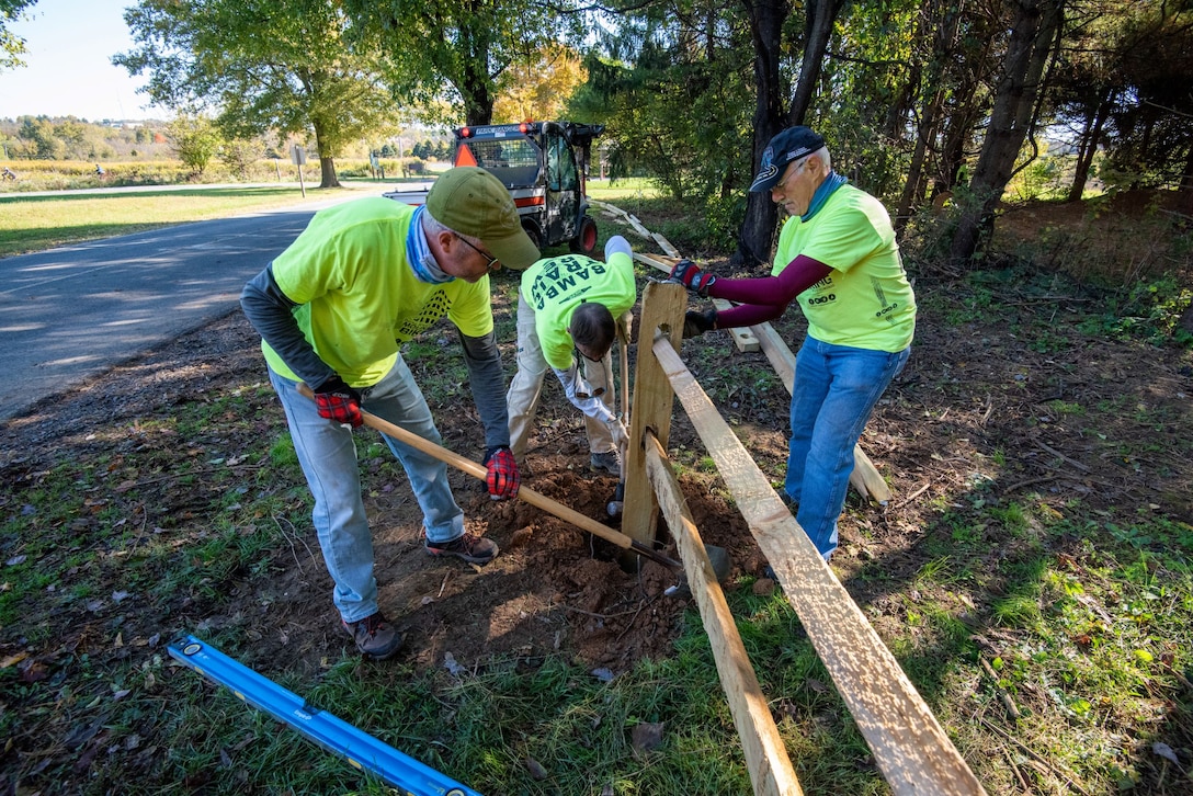 Volunteers repair a fence at Blue Marsh Lake