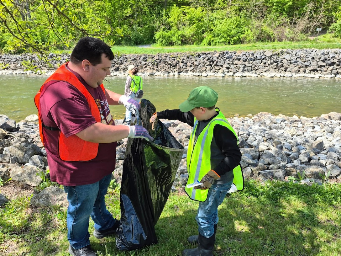 Volunteers help pick up litter during a clean up event.