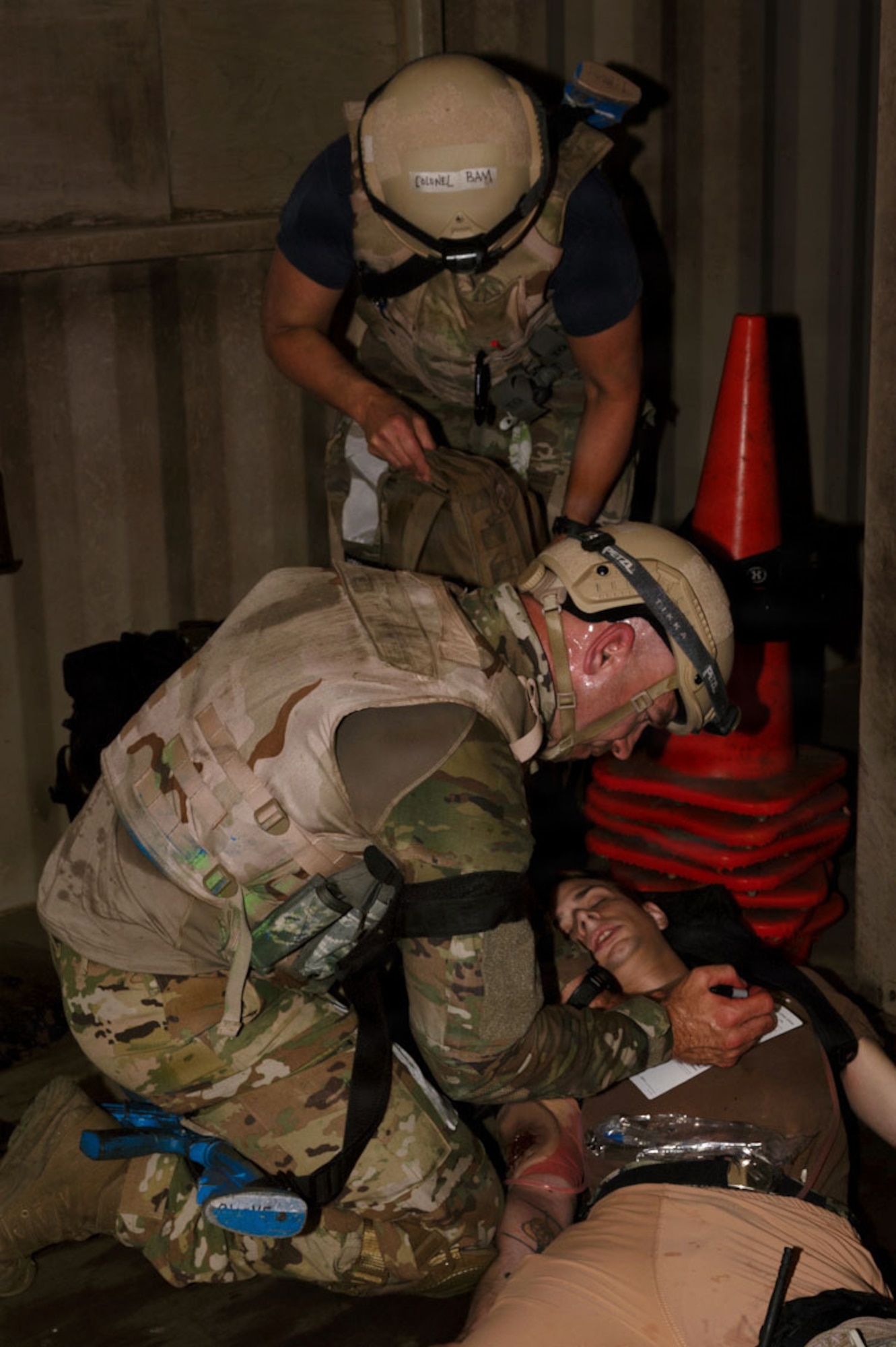 Medical personnel look at a patient's simulated injuries.