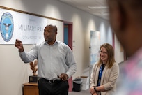 Christopher Cosby, Defense Finance and Accounting Service Total Force Pay Military Pay deputy director; and Becky Collet, DFAS TFP Army Pay Operations director, explain the relationship between Army military pay offices and DFAS during a tour of DFAS at the Maj. Gen. Emmett J. Bean Federal Center June 5, 2026. Seven AMPO employees visited USAFMCOM headquarters after attending a reserve pay course, sponsored by the U.S. Army Reserve Center, from June 1-5, 2026, in Indianapolis with the primary objective of enhancing the student’s the military pay knowledge on Army Reserve and Army National Guard pay in the AMPO network. (U.S. Army photo by Mark R. W. Orders-Woempner)