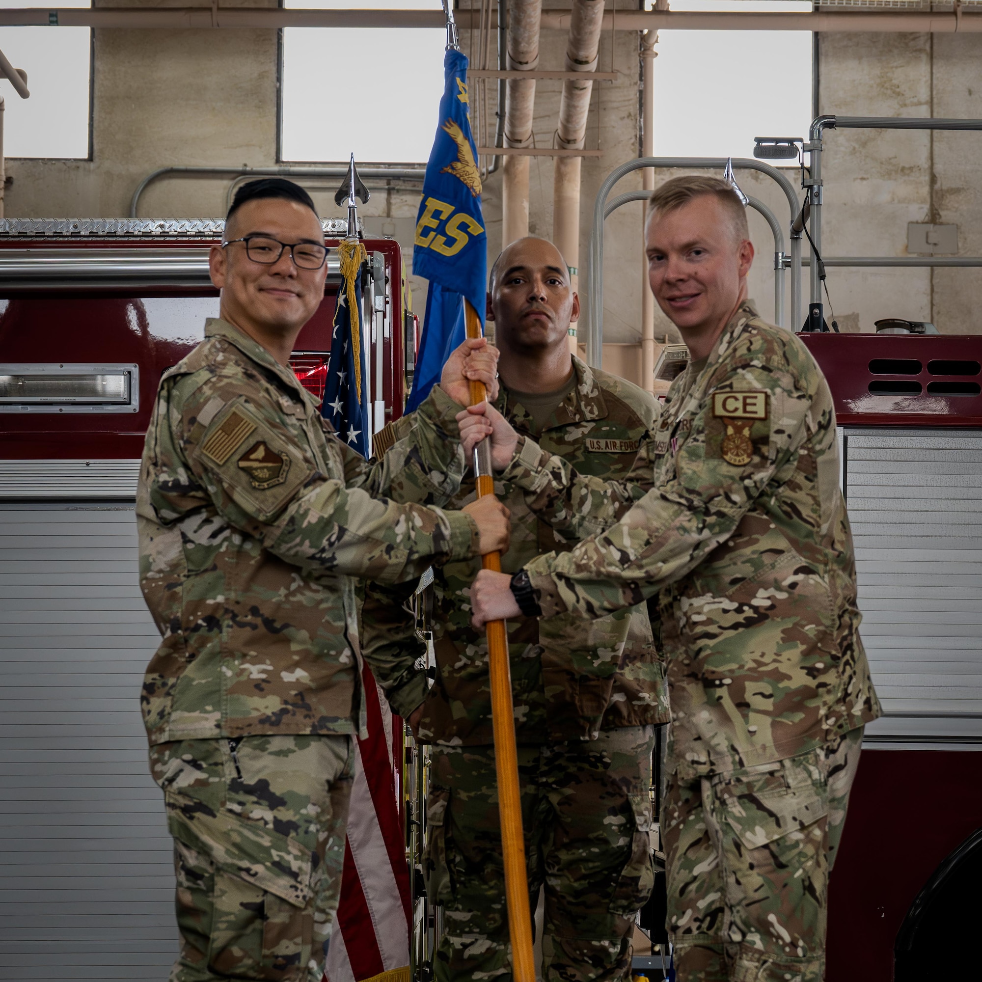 U.S. Air Force Lt. Col. Nathan Thomsen, 47th Civil Engineer Squadron (CES) outgoing commander, turns over the 47th CES guidon to Col. Peter Joo, 47th Mission Support Group commander, during the 47th CES change of command ceremony at Laughlin Air Force Base, Texas, June 9, 2026. The passing of the guidon to Joo signifies Thomsen's relinquish of command of the 47th CES. (U.S. Air Force photo by Airman 1st Class Harrison Sullivan)