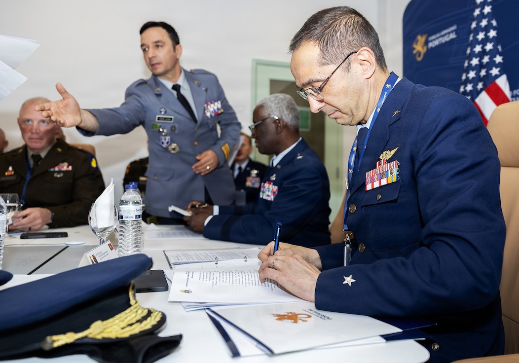 Portuguese Air Force Brig. Gen. João Paulo Nunes Vicente signs an agreement during staff talks in May between Illinois National Guard senior leaders and the Portuguese Armed Forces.
