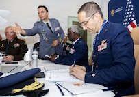 Portuguese Air Force Brig. Gen. João Paulo Nunes Vicente signs an agreement during staff talks in May between Illinois National Guard senior leaders and the Portuguese Armed Forces.
