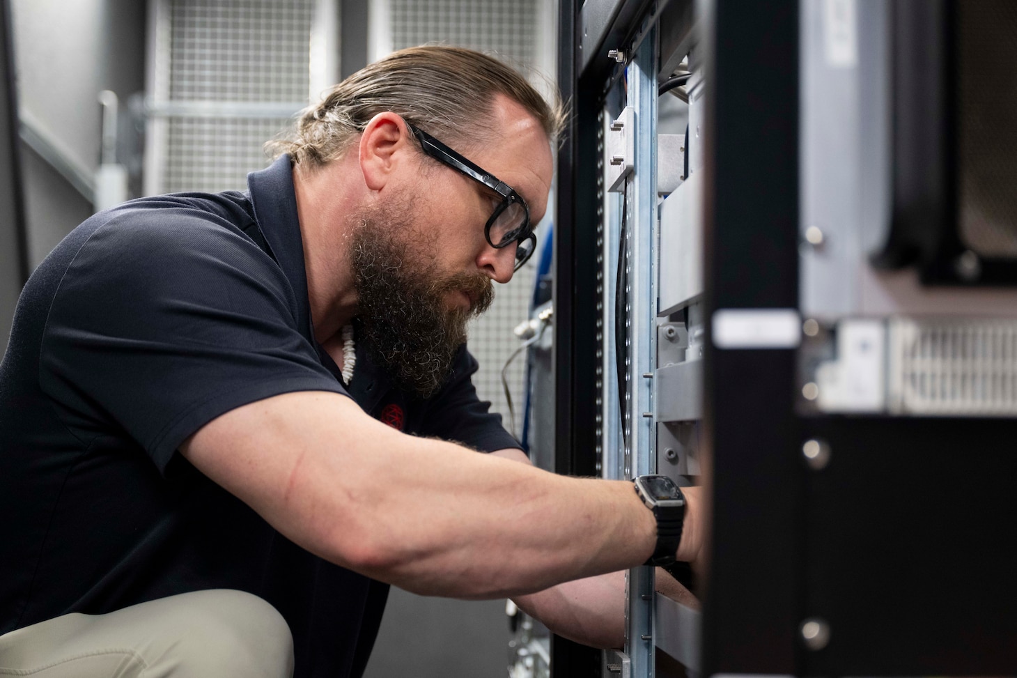 Nathaniel Janulis, L3 Harris systems support engineer, calibrates a satellite tracking antenna system as it is transferred from the U.S. Space Force (USSF) to the U.S. Naval Research Laboratory (NRL) at the Blossom Point Tracking Facility in Welcome, Md. March 5, 2026. NRL and USSF partnered to support expanded joint testing and operational readiness for space systems, reinforcing collaboration between the naval and space communities. (U.S. Navy photo by Sarah Peterson)