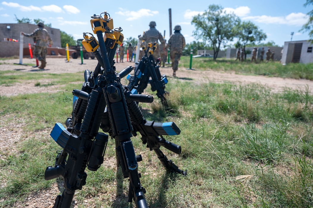 M4 carbines fitted with training devices rest between training scenarios during the inaugural Ready Airman Training Day at Goodfellow Air Force Base, Texas, Aug. 8, 2026. Developed collaboratively by Security Forces, Medical, Civil Engineer, Communications, and Wing Staff Agency personnel, the quarterly program is designed to build the combat skills Airmen need before deploying. (U.S. Air Force photo by Senior Airman James Salellas)