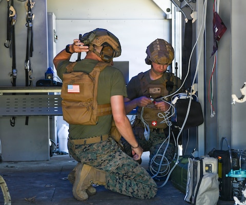 Hospital Corpsman 2nd Class Jeremiah Muniz, left, assigned to 2nd Medical Battalion, Bravo Company, and Hospital Corpsman 3rd Class Mats Zdon, assigned to 24th Marine Expeditionary Unit, set up medical equipment in a V-22 Osprey simulator during an En Route care (ERC) training at the Healthcare Simulation and Bioskills Center, on June 5, 2026. The ERC program is designed to train hospital corpsmen on necessary en route care, integrating high-fidelity simulators and hands-on training. Final testing for the ERC course was hosted by the Naval Medical Center Healthcare Simulation and Bioskills Center  (U.S. Navy photo by Mass Communication Specialist 2nd Class Justin Woods)