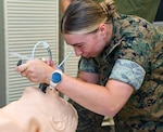 Hospital Corpsman 3rd Class Paige Stallings, assigned to Combat Logistics Battalion 24, intubates a simulated casualty during an En Route care (ERC) training at the Healthcare Simulation and Bioskills Center, on June 5, 2026. The ERC program is designed to train hospital corpsmen on necessary en route care, integrating high-fidelity simulators and hands-on training. Final testing for the ERC course was hosted by the Naval Medical Center Healthcare Simulation and Bioskills Center  (U.S. Navy photo by Mass Communication Specialist 2nd Class Justin Woods)