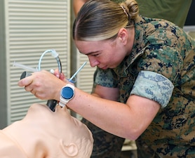 Hospital Corpsman 3rd Class Paige Stallings, assigned to Combat Logistics Battalion 24, intubates a simulated casualty during an En Route care (ERC) training at the Healthcare Simulation and Bioskills Center, on June 5, 2026. The ERC program is designed to train hospital corpsmen on necessary en route care, integrating high-fidelity simulators and hands-on training. Final testing for the ERC course was hosted by the Naval Medical Center Healthcare Simulation and Bioskills Center  (U.S. Navy photo by Mass Communication Specialist 2nd Class Justin Woods)