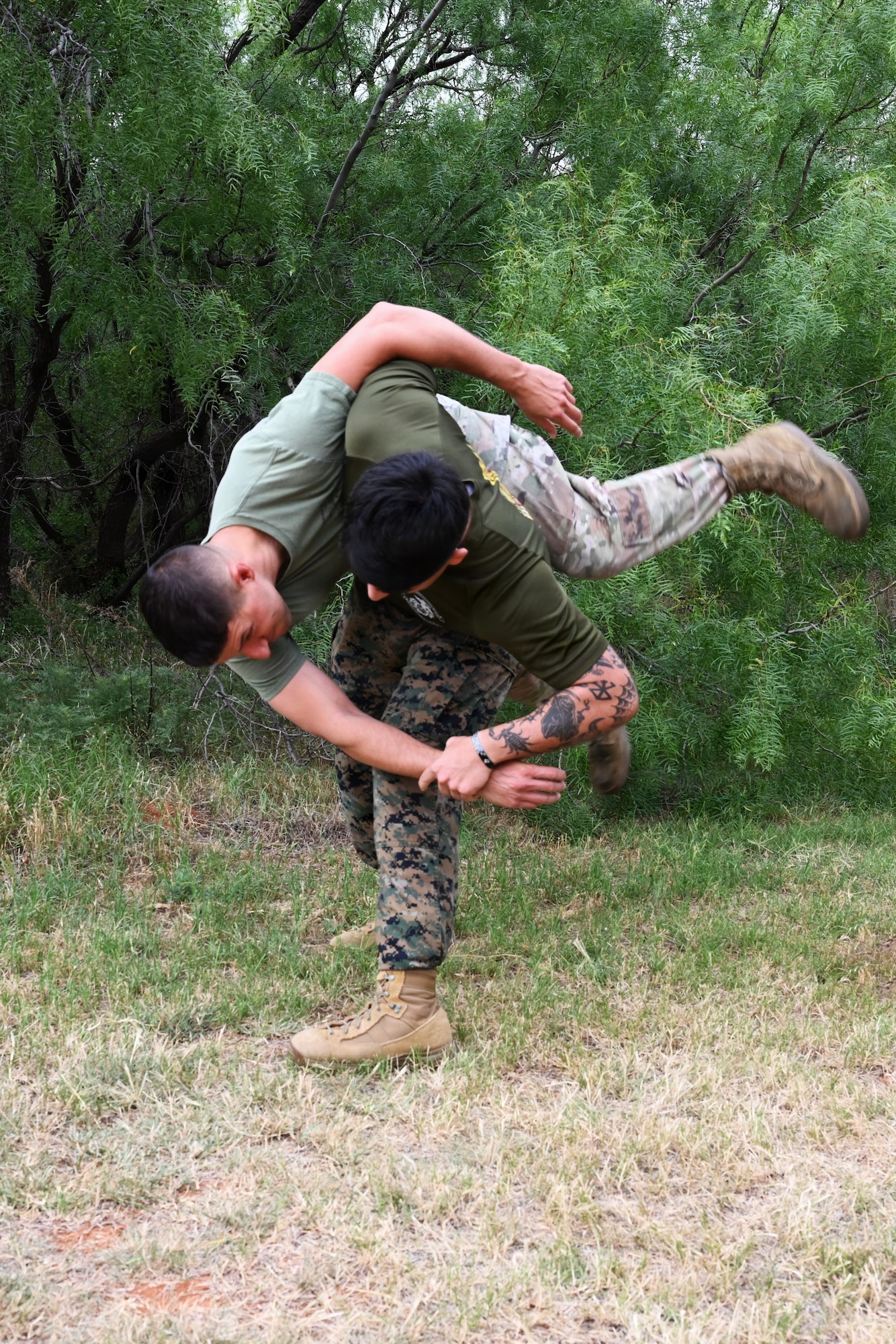 Airman and Marine wrestle