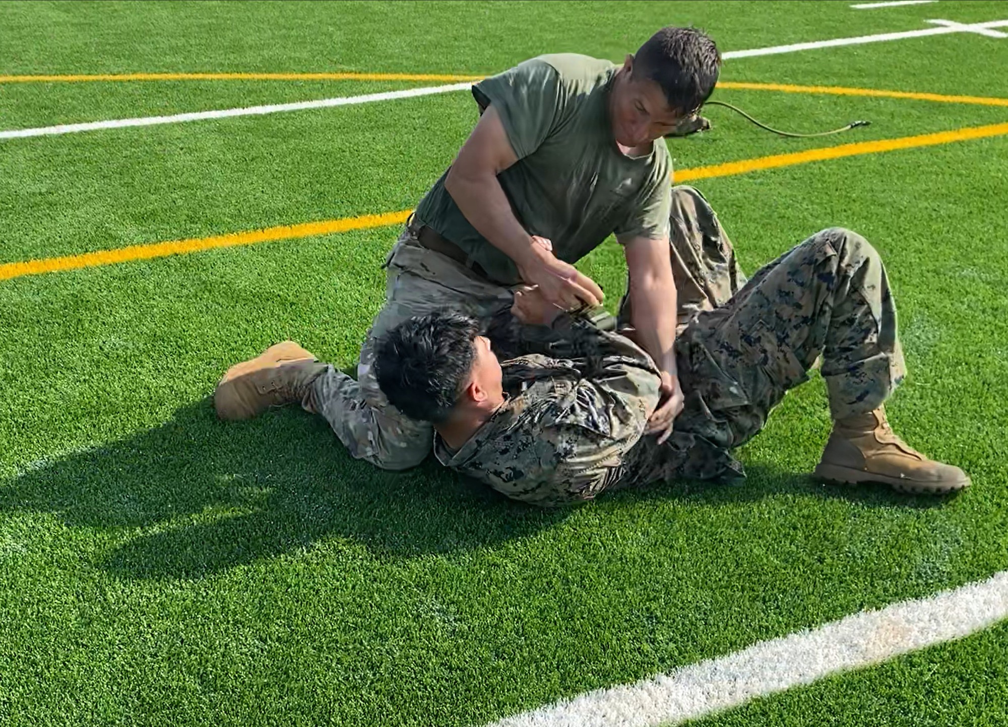 Airman and Marine wrestle