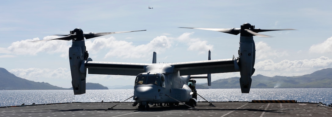 U.S. Marines and Royal Sailors load an MV-22B Osprey on the HMS Illustrious in the Philippine Sea, Nov. 27, 2013. The HMS Illustrious deployed to the Philippines in support of the Typhoon Haiyan disaster relief effort during Operation Damayan. (U.S. Marine Corps photo by Lance Cpl. Luis A. Rodriguez III/ Released)