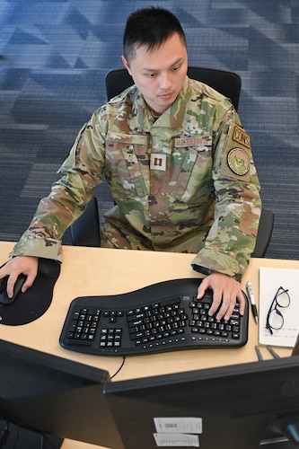 Capt. Haotian Xia, Kessel Run contracts manager, checks contracting documents here, June 4, 2026. The Department of the Air Force Portfolio Acquisition Executive for Command, Control, Communications and Battle Management realigned its contracting process to a single Chief of the Contracting Office and Senior Contracting Official, delegating contracting authorities as close as possible to the units focused on mission outcomes.