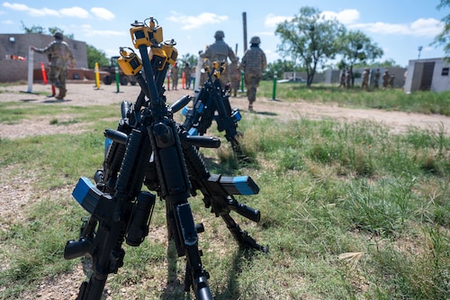 M4 carbines fitted with training devices rest between training scenarios during the inaugural Ready Airman Training Day at Goodfellow Air Force Base, Texas, Aug. 8, 2026. Developed collaboratively by Security Forces, Medical, Civil Engineer, Communications, and Wing Staff Agency personnel, the quarterly program is designed to build the combat skills Airmen need before deploying. (U.S. Air Force photo by Senior Airman James Salellas)