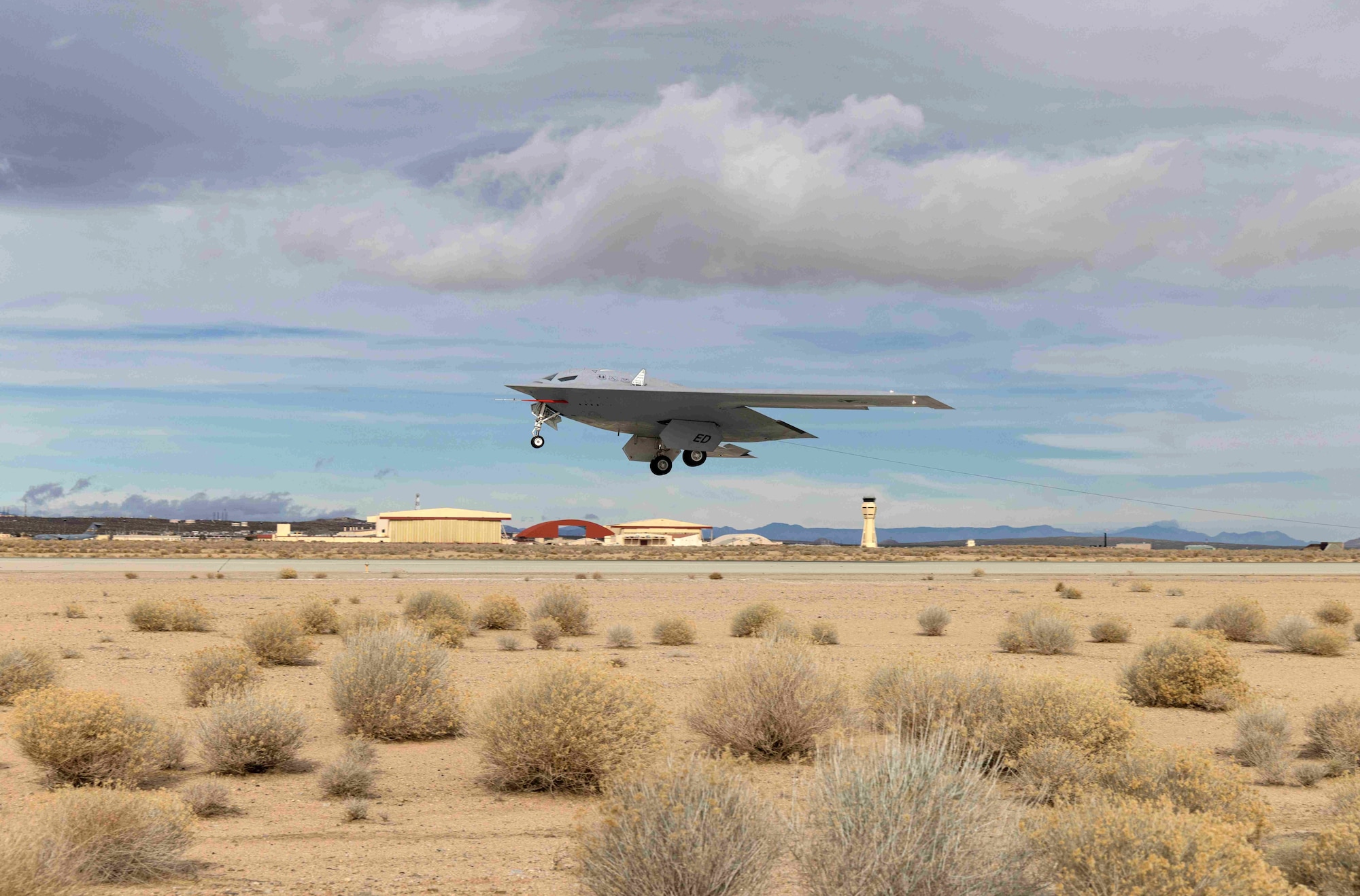 A B-21 Raider conducts flight tests, which includes ground testing, taxiing and flying operations, at Edwards Air Force Base, California, where it continues to make progress toward becoming the backbone of the U.S. Air Force bomber fleet. The B-21 will possess the range, access, and payload to penetrate the most highly contested threat environments and hold any target around the globe at risk. The B-21 program is on track to deliver aircraft in the mid-2020s to Ellsworth Air Force Base, South Dakota, which will be the first B-21 main operating base and location for the B-21 formal training unit. (U.S. Air Force photo)