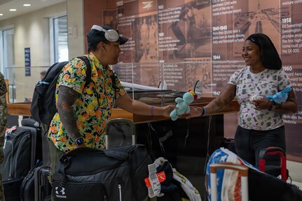 U.S. Army Capt. Channda Mitchell (left) shares memorabilia plush with U.S Army Sgt. 1st Class Valerie Watkins after arriving at San Antonio International Airport for the 2026 Warrior Games June 8, 2026.