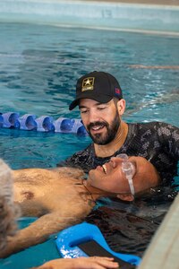 U.S. Army Spc. Jeyson Ruiz participates in swimming training session with support from  Eli English, Fort Benning’s Adaptive Reconditioning Lead, at Team Army’s Warrior Games Training Camp in San Antonio, Texas, June 9, 2026.
