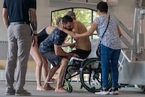 U.S. Army Spc. Jeyson Ruiz receives assistance from Team Army support cadre after completing a swimming training session during Team Army’s Warrior Games Training Camp in San Antonio, Texas, June 9, 2026.
