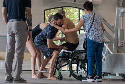 U.S. Army Spc. Jeyson Ruiz receives assistance from Team Army support cadre after completing a swimming training session during Team Army’s Warrior Games Training Camp in San Antonio, Texas, June 9, 2026.