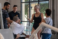 U.S. Army Spc. Jeyson Ruiz speaks with Krista Argiolas, a Team Army Recovery Consultant, following a swimming training session during Team Army’s Warrior Games Training Camp in San Antonio, Texas, June 9, 2026.