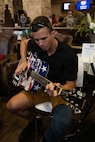 U.S. Army Capt. Eric Blake plays guitar at the welcome lunch hosted by the USO in anticipation of the 2026 Warrior Games