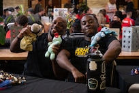 Retired U.S. Army Cpt. Tony J. Smith (left) and Cpl. Delas Bush (right) pose for a photo at the welcome lunch hosted by the USO in anticipation