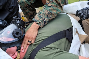 260608-N-HS756-1036 LIEPAJA, Latvia (June 8, 2026) Hospital Corpsman 3rd Class Dante Hendrix, assigned to 2nd Light Armored Reconnaissance Battalion (2nd LAR BN), checks vital signs during a Chemical, Biological, Radiological, and Nuclear (CBRN) training evolution during exercise Baltic Operations (BALTOPS) 2026, in Liepaja, Latvia, June 8, 2026. BALTOPS 2026, the premiere maritime-focused exercise in the Baltic Sea region, provides a unique training opportunity to strengthen combined response capabilities critical to preserving freedom of navigation and security in the Baltic Sea. (U.S. Navy photo by Mass Communication Specialist 3rd Class Sisi Lopez Barahona)