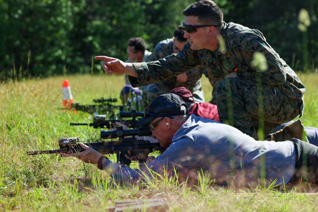 U.S. Marine Corps Sgt. Jackson Forsythe, a combat marksmanship team instructor, Weapons Training Battalion, Marine Corps Base Quantico, teaches Raymond Rogers, director of career services, Texas State University, how to sight in during the Educators Workshop on MCBQ, Va., June 4, 2026. The Educators Workshop gives college educators, administrators, and coaches from across the country the opportunity to see how Marines are recruited, trained, and developed into leaders. (U.S. Marine Corps photo by Cpl. Brenna Ritchie)