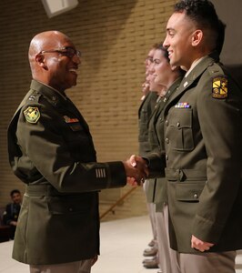 Maj. Gen. Rodney Boyd, The Adjutant General of Illinois and Commander of the Illinois National Guard, congratulates 2nd Lt. Joshua Van Den Broeck, during Northern Illinois University’s Army ROTC Commissioning Ceremony.