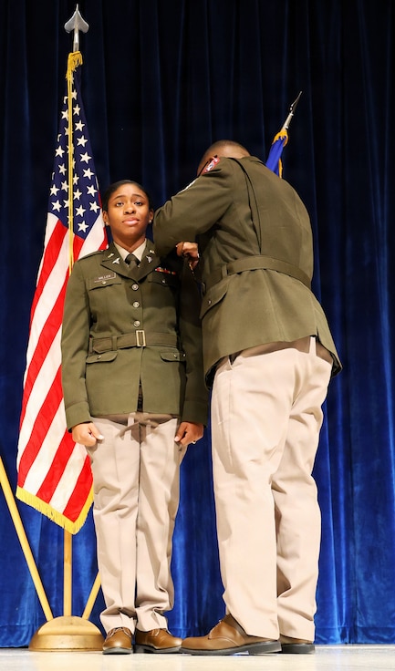 Staff Sgt. Anthony May pins second lieutenant rank on Knayjah Miller during Northern Illinois University’s Army ROTC Commissioning Ceremony, May 15.