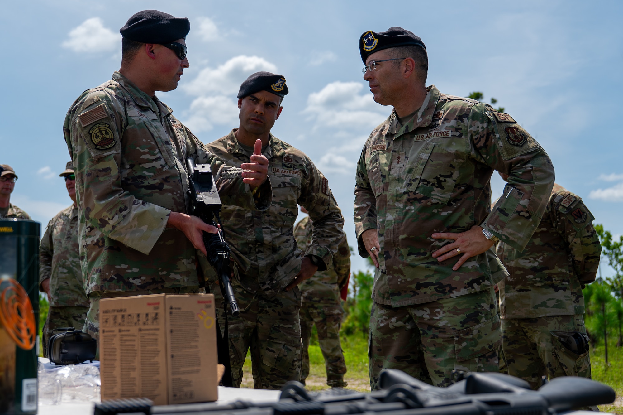 U.S. Air Force Master Sgt. Jonathan Calo, 325th Security Forces Squadron logistics and readiness superintendent, and Senior Master Sgt. Reginald Walters, 325th SFS future operations superintendent, explain the capabilities of a new counter-drone weapon system to Maj. Gen. Thomas P. Sherman, Air Force Installation and Mission Support Center commander, at Tyndall Air Force Base, Florida, June 3, 2026. The training highlighted the 325th SFS's enhanced readiness and its ability to equip Airmen with the skills needed to counter modern airborne threats. (U.S. Air Force photo by Airman 1st Class Rosario Garcia)