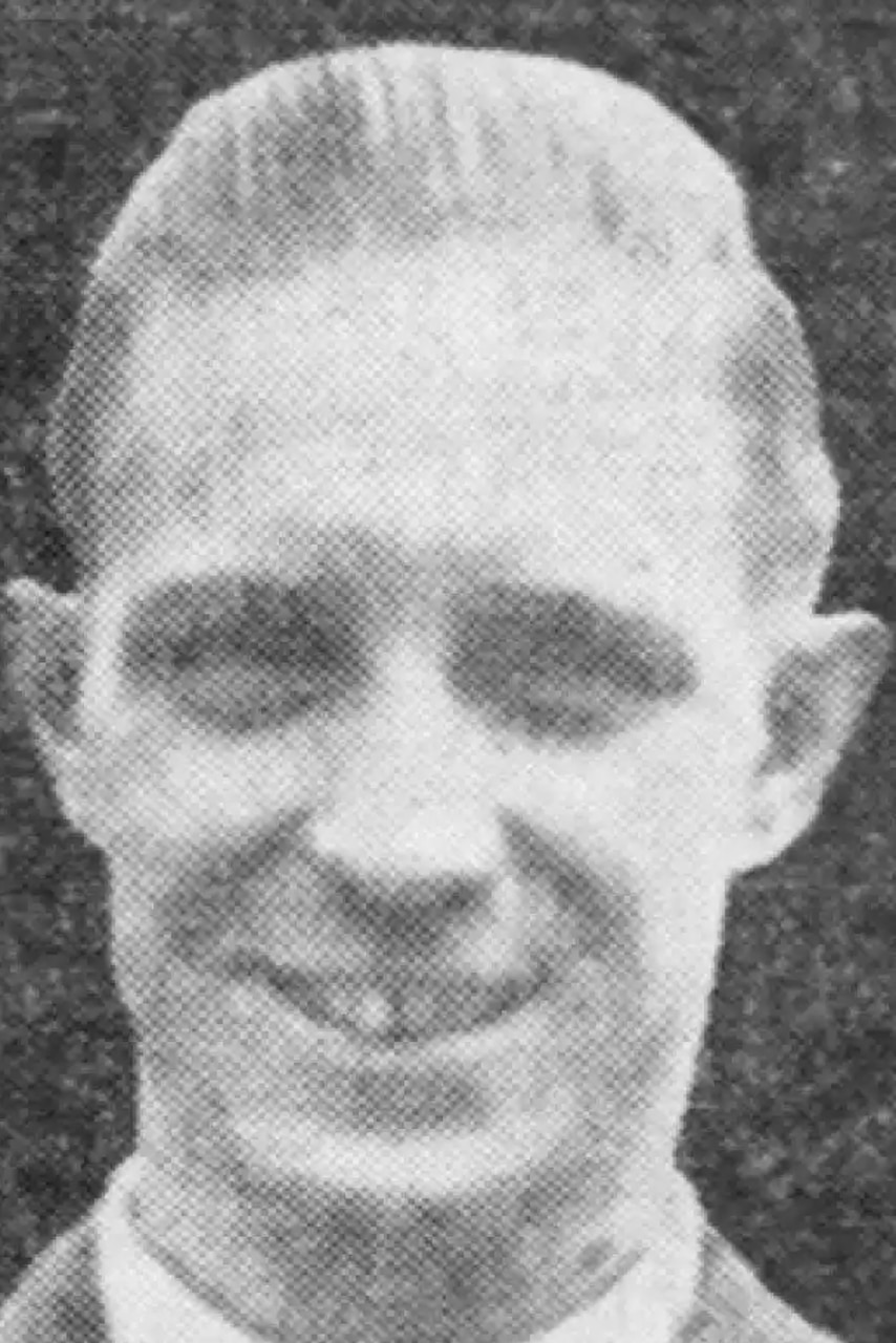 A man smiles and poses for a photo.
