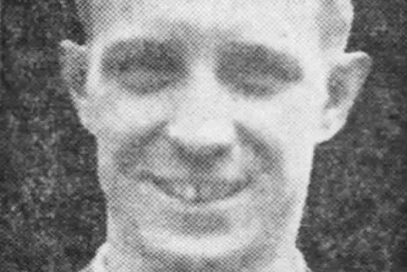 A man smiles and poses for a photo.