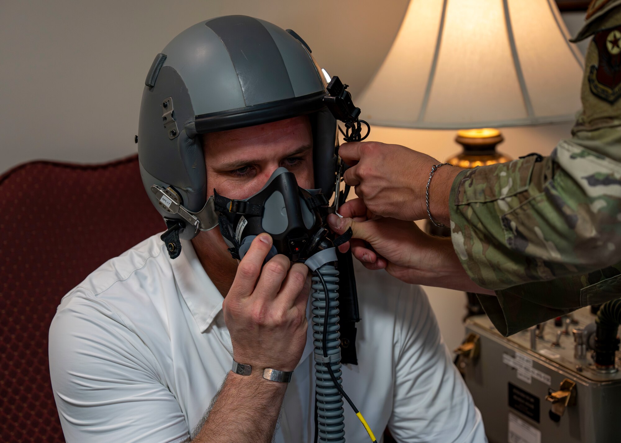 Derrick Anderson, Assistant Secretary of War for Special Operations and Low-Intensity Conflict, is fitted for a helmet by an aircrew flight equipment technician