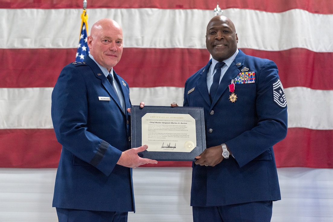 U.S. Air Force Chief Master Sgt. Marlon Burton, right, the command chief of the Illinois Air National Guard, receives a Certificate of Appreciation during his retirement ceremony in Peoria, Illinois, May 3, 2026.