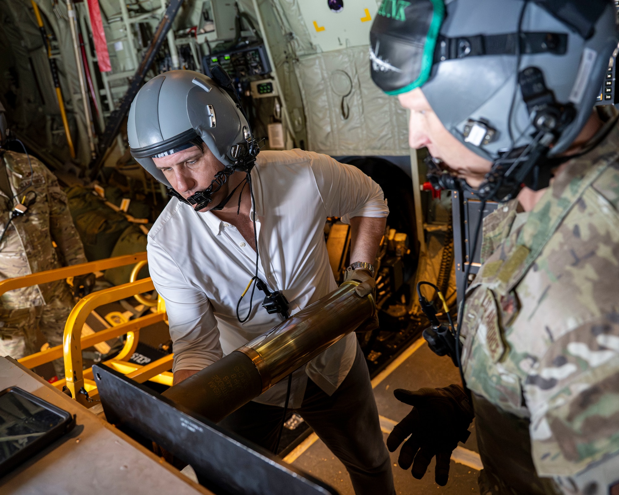 Derrick Anderson, Assistant Secretary of War for Special Operations and Low-Intensity Conflict, loads a 105 mm round aboard a 1st Special Operations Wing AC-130J Ghostrider during a familiarization flight