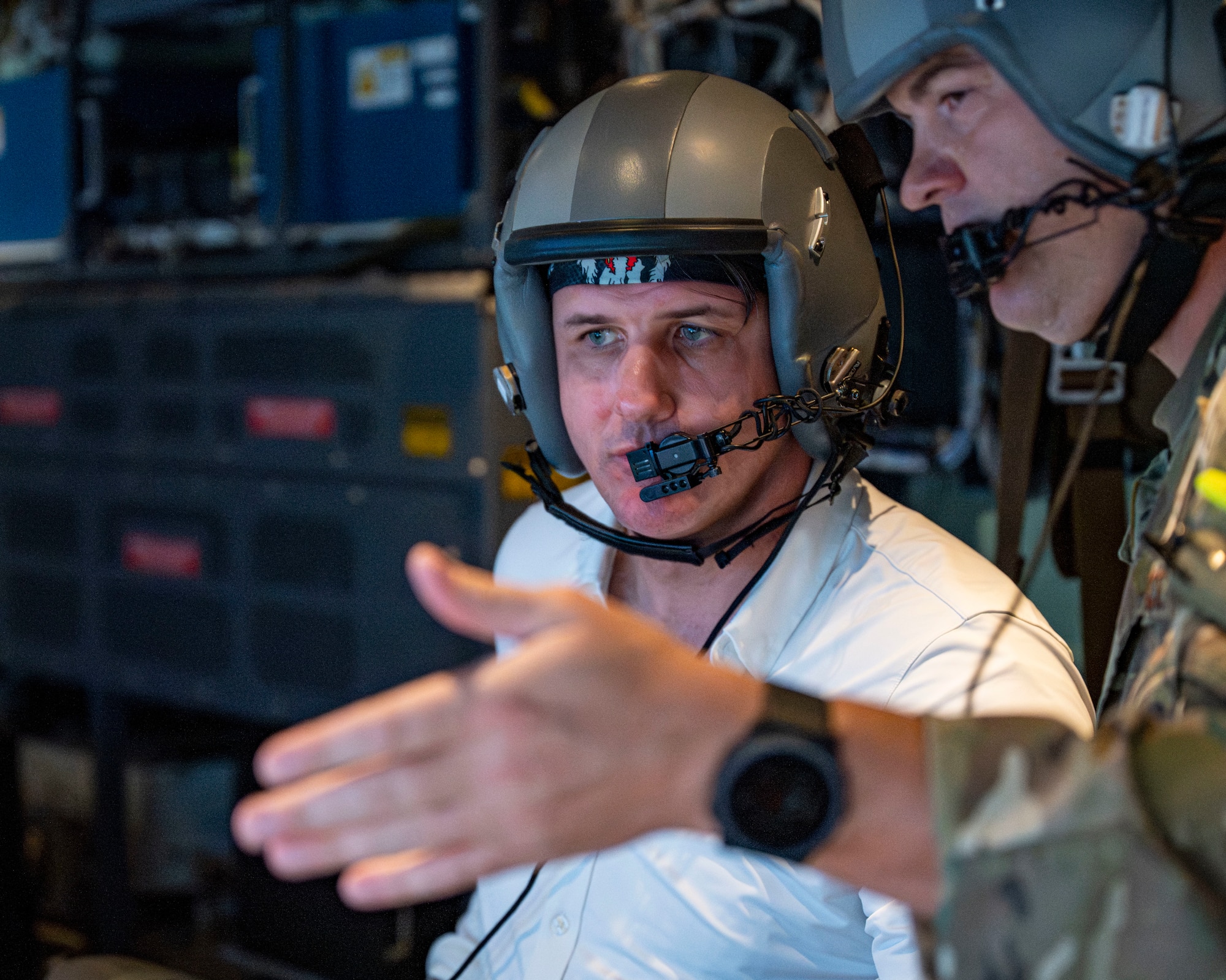 Derrick Anderson, Assistant Secretary of War for Special Operations and Low-Intensity Conflict, speaks with a weapons systems officer aboard a 1st Special Operations Wing AC-130J Ghostrider during a familiarization flight