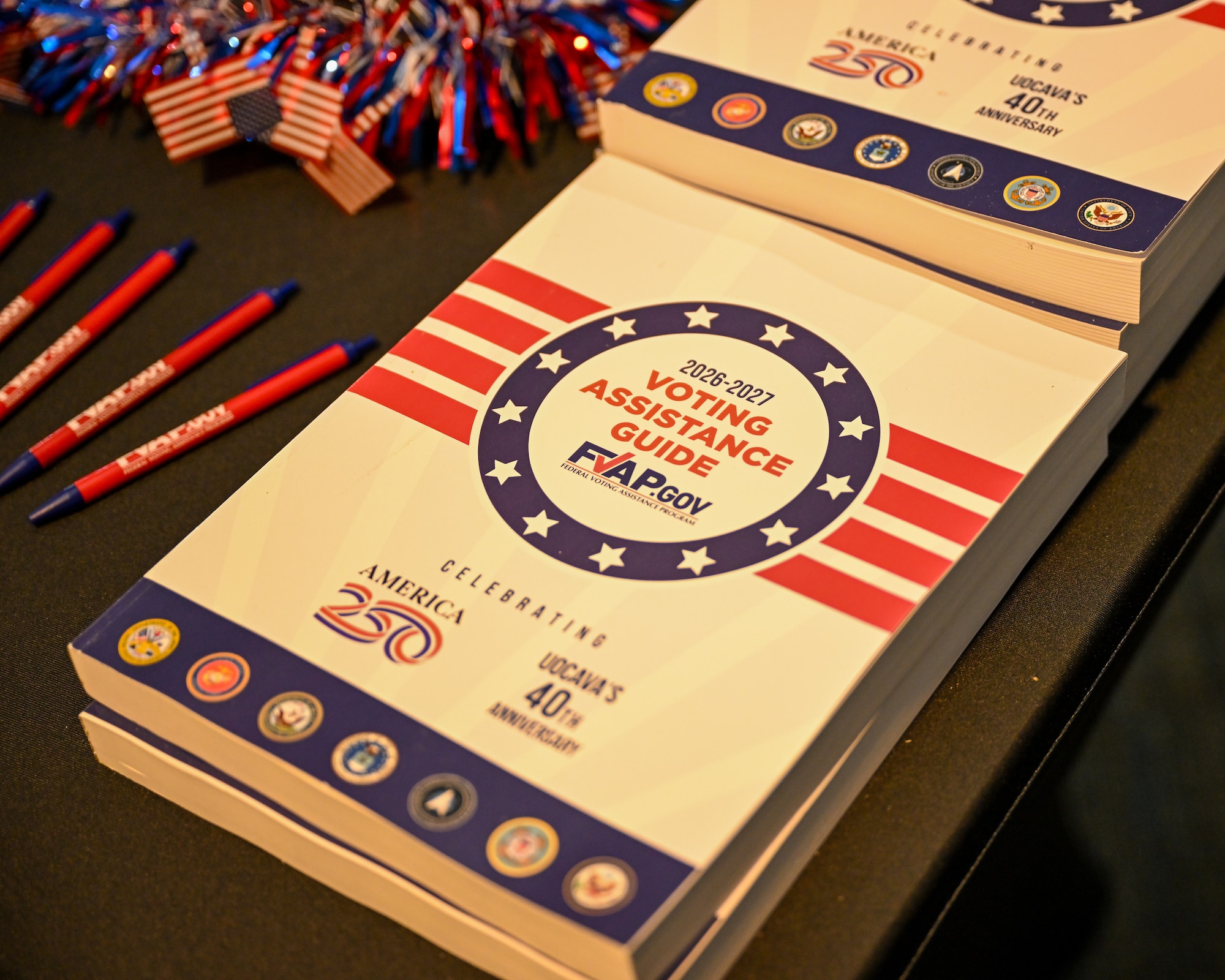 The FVAP voting assistance guide sits on the corner of the table that is decorated patriotically.