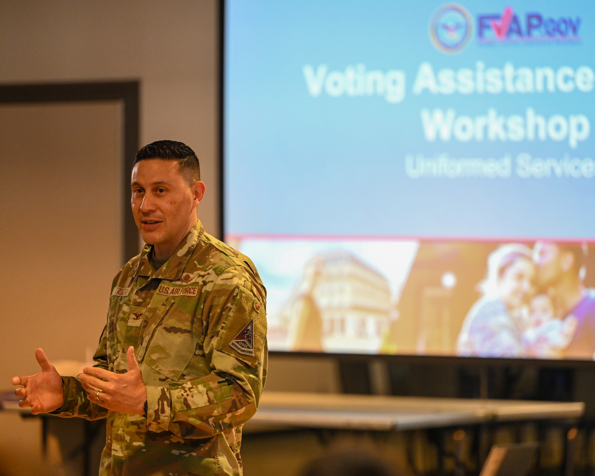 Col. Ruiz stanind in front of the audience gives the opening remarks at the workshop.