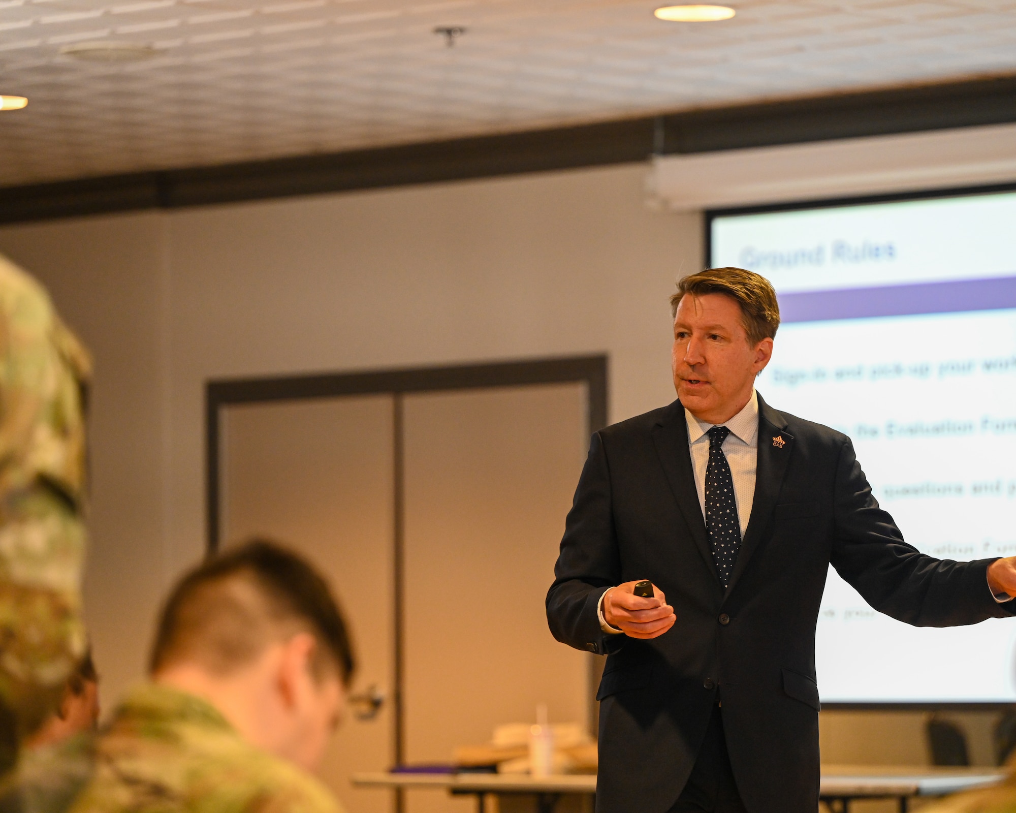 Mr. Wiedmann, standing at the front of the ballroom addresses the audience members at the start of the workshop.