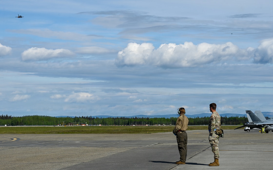 Aircrew observe F-16 Fighting Falcons assigned to the 425th Fighter Squadron from Luke Air Force Base, Ariz., take off for a RED FLAG-Alaska 26-2 sortie at the flight line on Eielson Air Force Base, Alaska, June 1, 2026.
