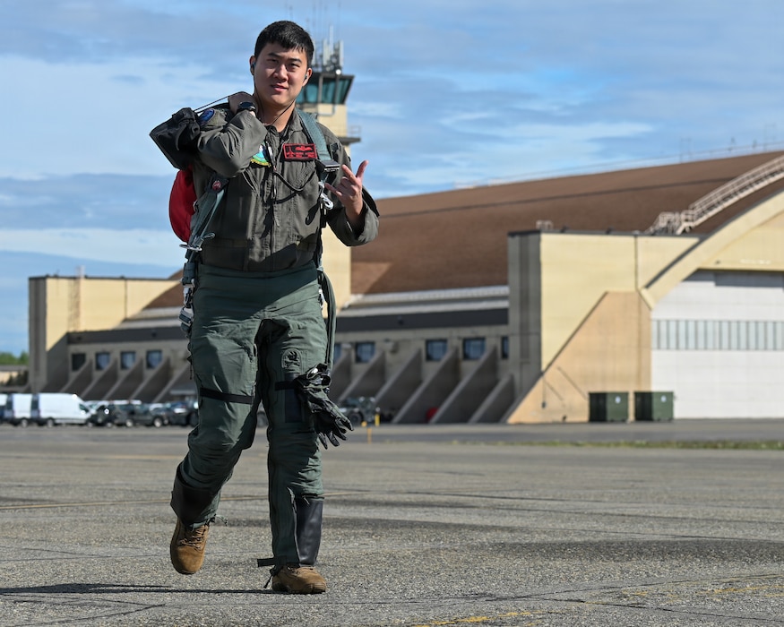 Republic of Singapore Air Force Maj. Music Leong, a F-16 Fighting Falcon pilot assigned to the 425th Fighter Squadron from Luke Air Force Base, Ariz., gives a unit’s heritage hand sign on the flight line during RED FLAG-Alaska 26-2 at Eielson Air Force Base, Alaska, June 1, 2026.