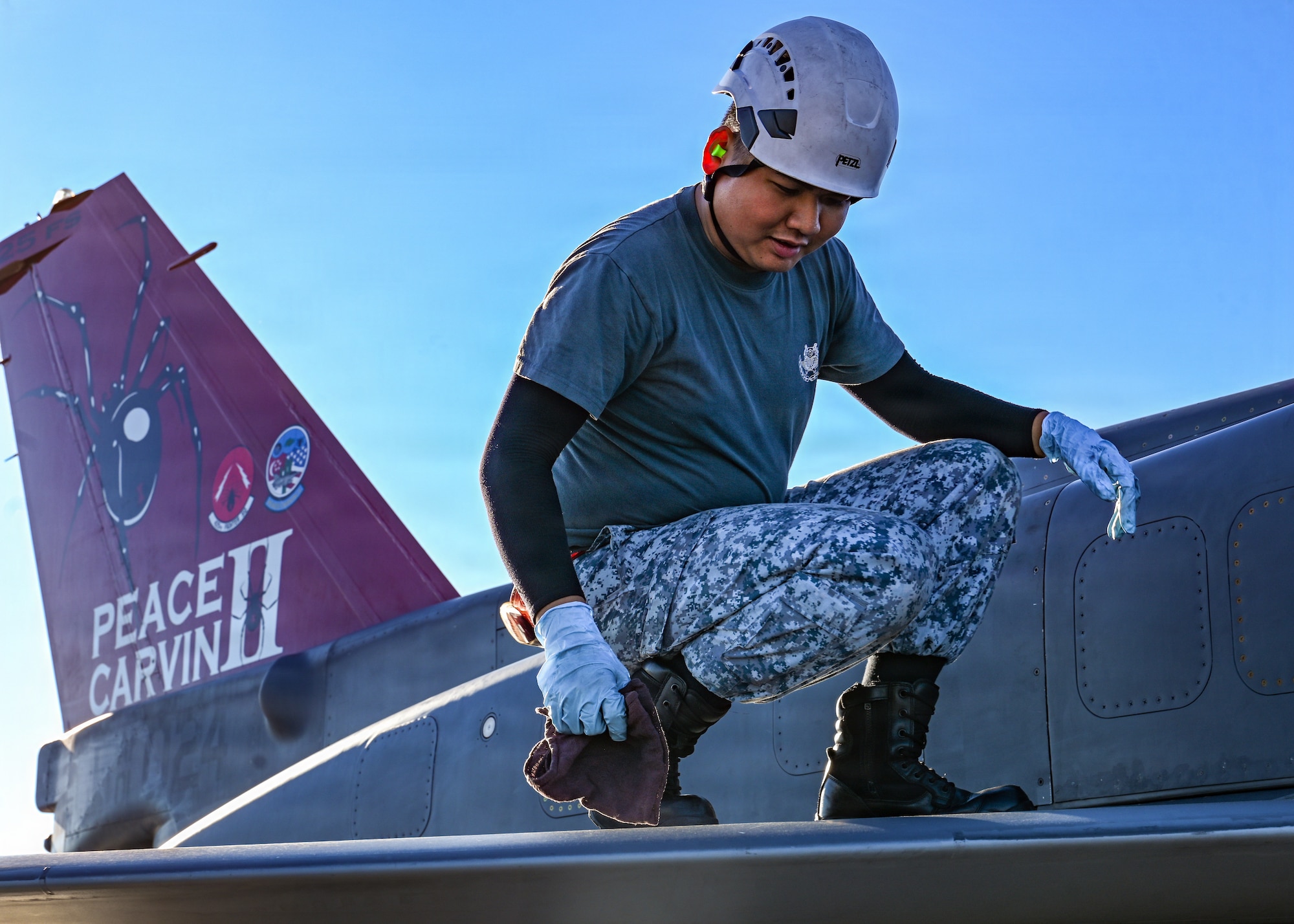 Republic of Singapore Air Force Military Expert 2 Liew Li Qiang, a 425th Fighter Squadron maintainer, wipes down a F-16 Fighting Falcon assigned to the 425th FS from Luke Air Force Base, Ariz., on the flight line at Eielson Air Force Base, Alaska, during RED FLAG-Alaska 26-2, June 3, 2026.