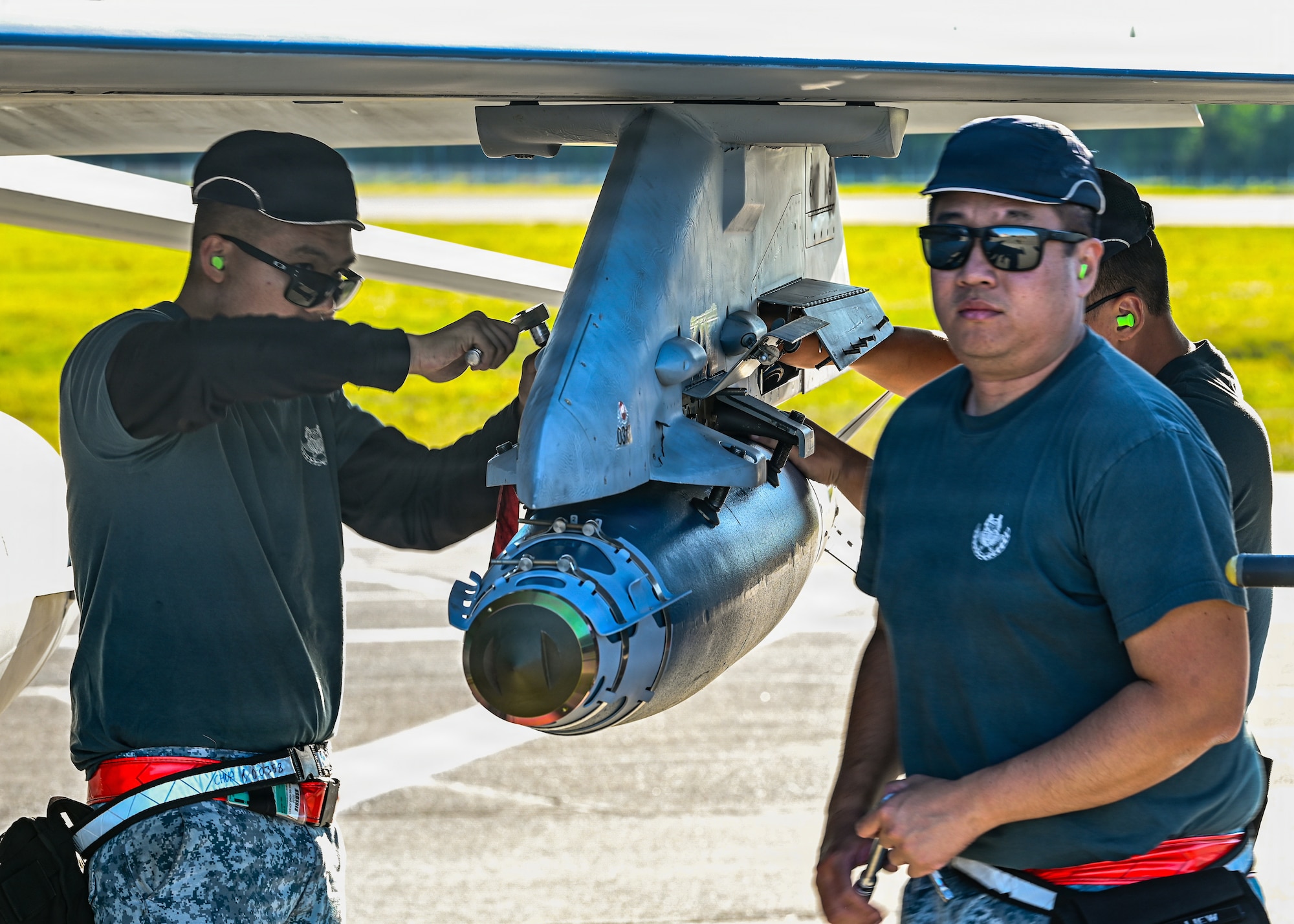 Republic of Singapore Air Force maintainers assigned to the 425th Fighter Squadron attach a BDU-50 inert practice bomb onto F-16 Fighting Falcons on the flight line at Eielson Air Force Base, Alaska, during RED FLAG-Alask 26-2, June 3, 2026.