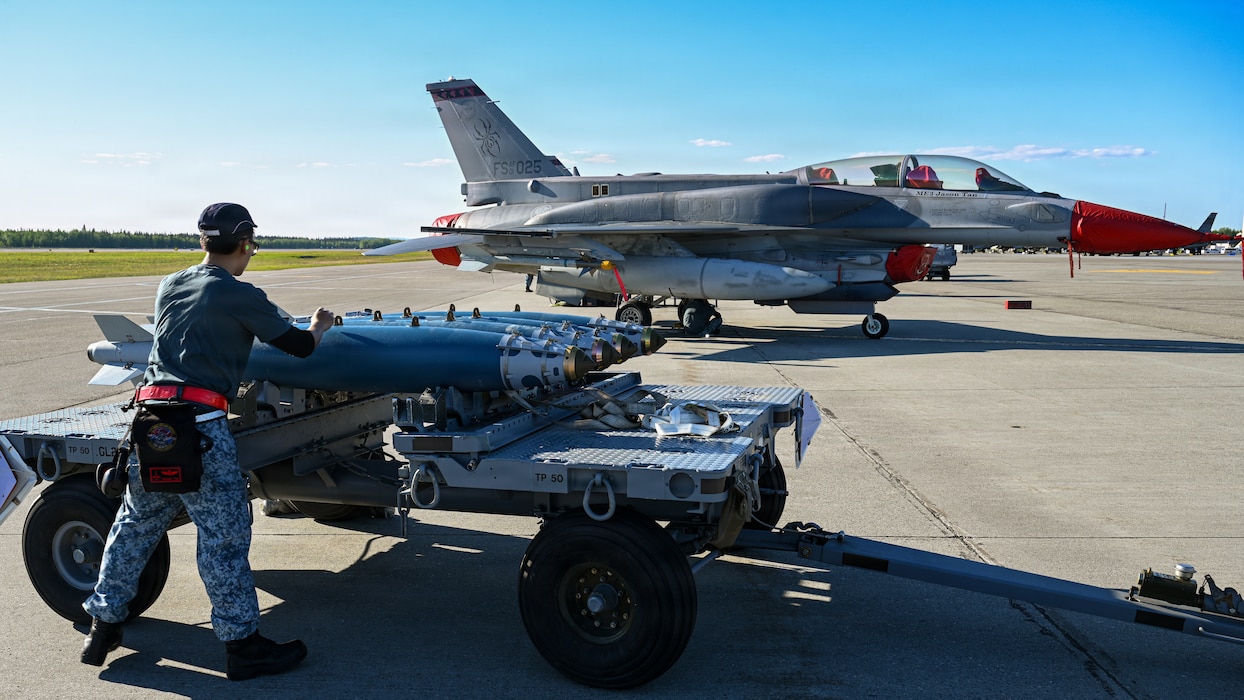 Republic of Singapore Air Force Military Expert 1 Travis Toh, a 425th Fighter Squadron maintainer, prepares BDU-50 inert practice bombs for loading on the flight line at Eielson Air Force Base, Alaska, during RED FLAG-Alask 26-2, June 3, 2026.