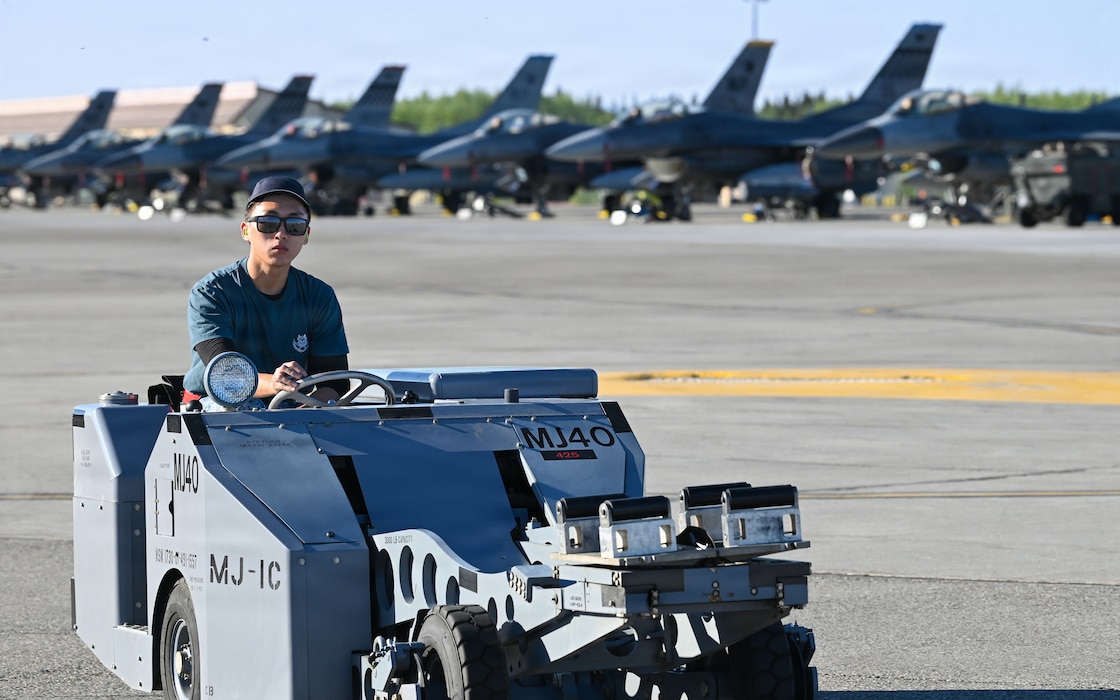 Republic of Singapore Air Force Military Expert 1 Travis Toh, a 425th Fighter Squadron maintainer, observes a BDU-50 inert practice bomb as he prepares to transport it on the flight line at Eielson Air Force Base, Alaska, during RED FLAG-Alask 26-2, June 3, 2026.