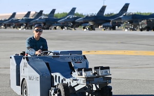 Republic of Singapore Air Force Military Expert 1 Travis Toh, a 425th Fighter Squadron maintainer, observes a BDU-50 inert practice bomb as he prepares to transport it on the flight line at Eielson Air Force Base, Alaska, during RED FLAG-Alask 26-2, June 3, 2026.