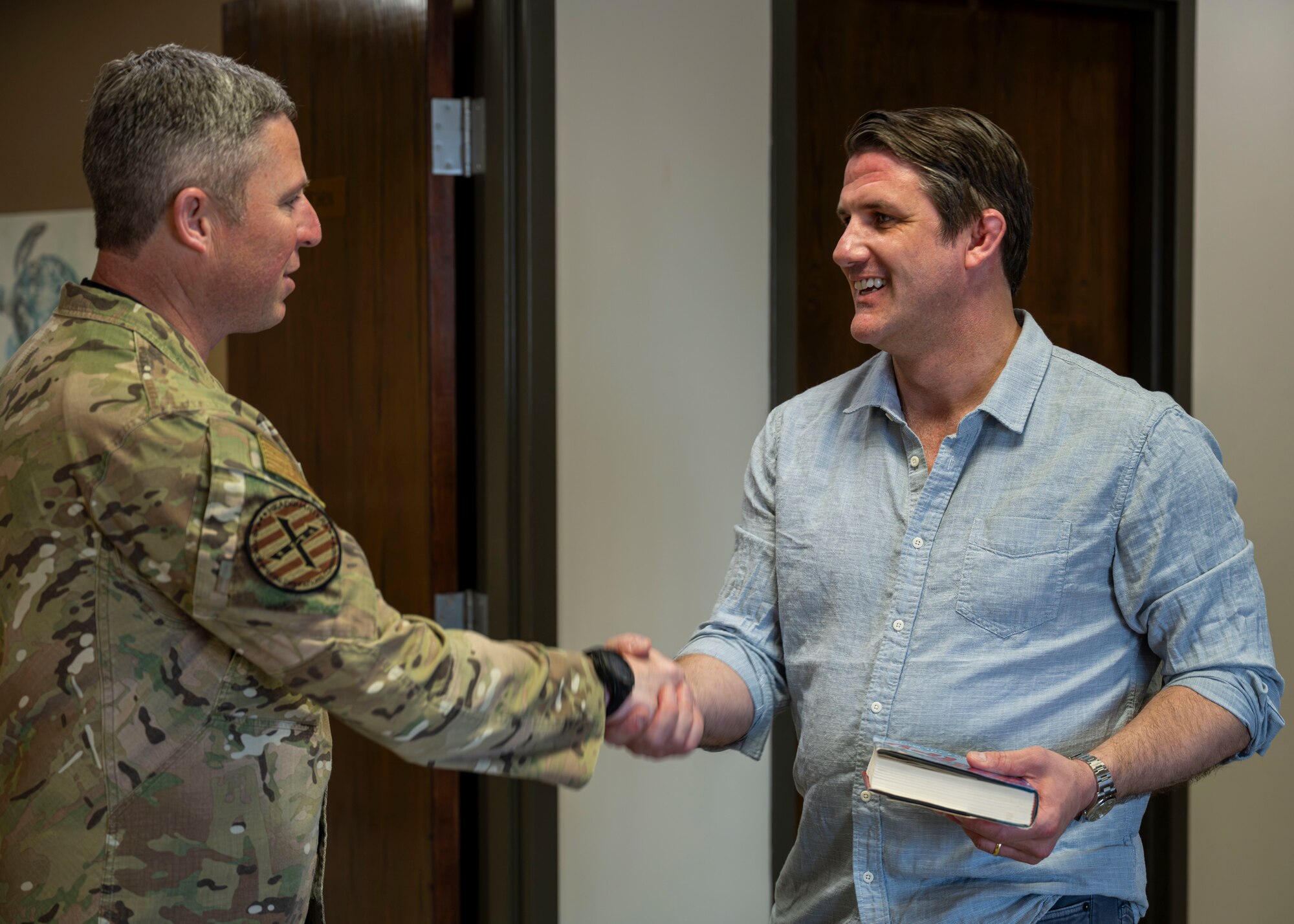 Derrick Anderson, Assistant Secretary of War for Special Operations and Low-Intensity Conflict, shakes hands with Lt. Gen. Mike Conley, commander of Air Force Special Operations Command.